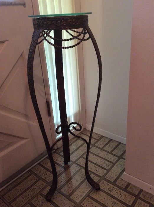 Iron plant stand with glass top.