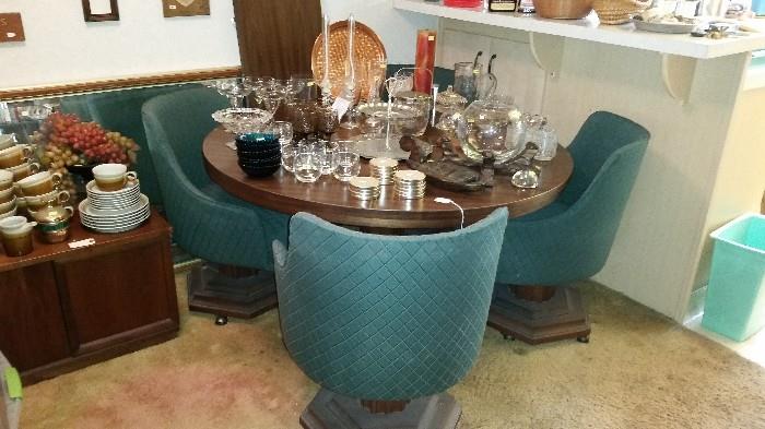 Mid century dining set with leaf and 4 swivel chairs.