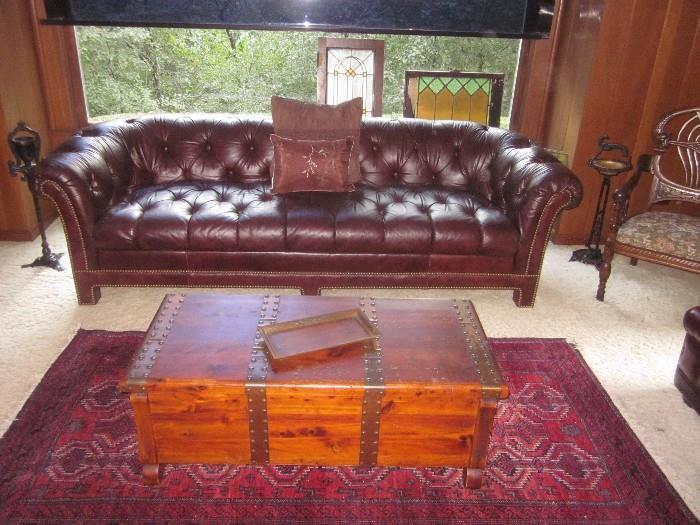 Leather sofa, trunk, rug, stained glass