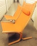 Highback Siesta Bentwood Chair with Ottoman. (Pictured with shorter version for comparison only.)
High-back Siesta chair and attached head pillow with ottoman, circa 1964, made of orange sailcloth and wood. Chair measures 39”H x 25”W x 17”D, ottoman: 17”H x 25”W x 21”D (not pictured.) Base measures 28” from front to back. These are not marked however they could possibly be by Westnofa, the quality is that good.
Some discoloring to the sailcloth as expected with the age of the chair. Wood oil will bring back the wood to perfection. (Shown here with the smaller version for size comparison only.) Asking price  $750. NOW $500!