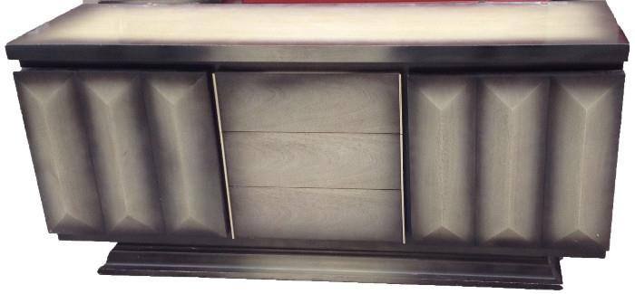 Rare Sapphire Mist 9-drawer Basset Dresser / Buffet and Mirror. (Mirror pictured separately.) 
This handsome piece is most likely from the 1950s. Leo Jiranek was the main designer for Basset at the time, however in doing research Paul Bruno is also referenced as the possibly designer. This is an extraordinary and rare design with dramatic angled relief side panels and exquisite brass hardware. In some Basset advertisements the color is noted as Sapphire Mink and in others Sapphire Mist.
Top of the dresser needs some work. Additional photos available upon request. Asking price for the dresser and mirror $2,500. NOW $2,000! (Set price  NOW $3,200. Dresser, mirror, headboard and two night stands.)