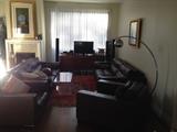 Roche Bobois sofas, armchairs and ottomans, mid century lamp, Lucite table, BO TV, Art, Moroccan rug