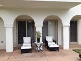 Rattan patio furniture, table and plants