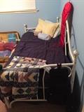 Twin daybed, quilts and bedding.
