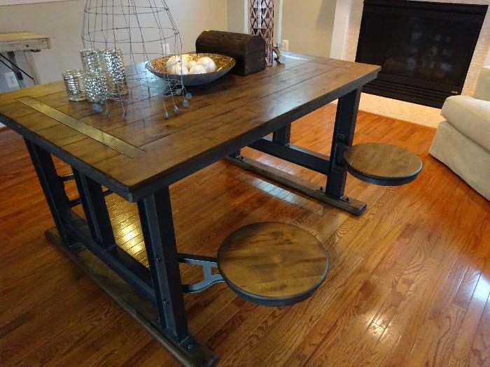 The desk converted into a dinning table with swivel chairs that hide under the table. The table is hard wood and iron. Its in excellent condition.