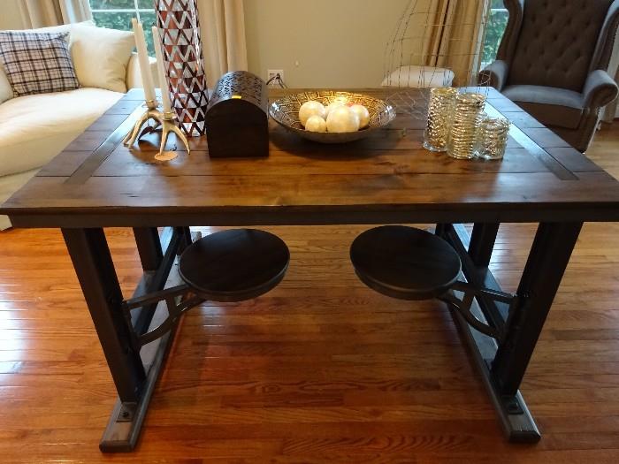 The desk converted into a dinning table with swivel chairs that hide under the table. The table is hard wood and iron. Its in excellent condition.