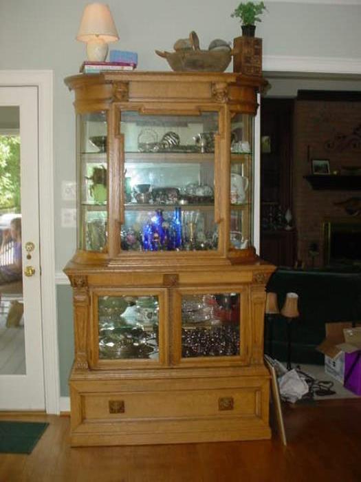 Exquisite tall antique china / curio cabinet filled with sterling silver, collectible glass, carnival glass punch bowl, and so much more