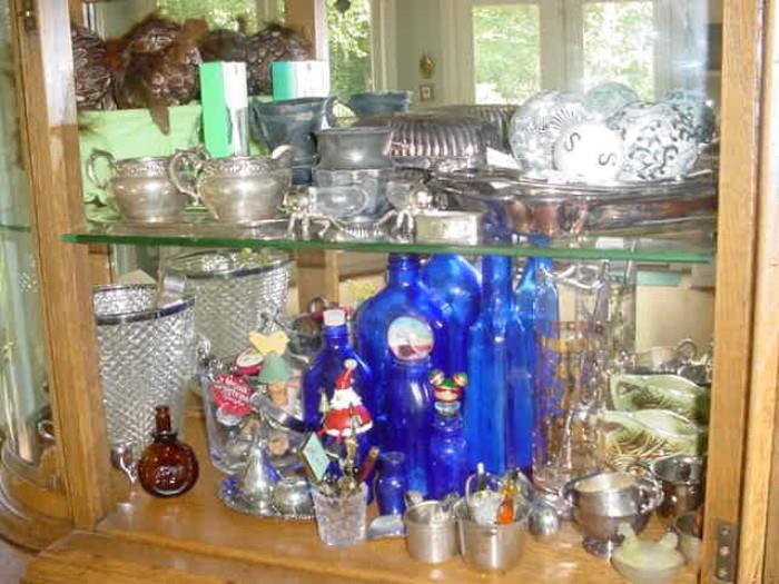 Some of the contents of that large curio cabinet..including sterling silver, crystal, art pottery and so much more