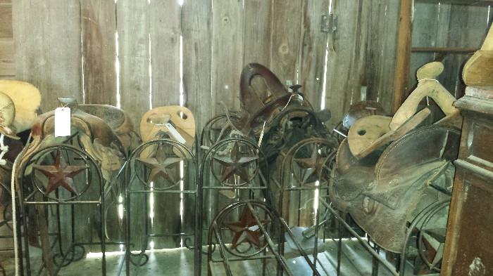 Some of the more than 24 saddles for sale. Various types and conditions.