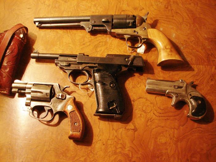 Walther P-38 serial #7972C 9mm in center was a presentation to Edward Cole when president of General Motors. Remington Derringer over/under, Smith & Wesson Model 36 .38 special, Navy Arms Replica black powder C & B .44 cal