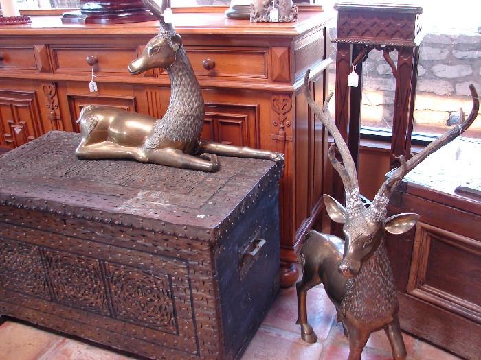 Brass Thai deer and one of several carved chests