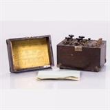 LOT 30 - A Wheatstone Bridge
Dimensions: H: 7 1/4 W: 9 1/4 D: 7 1/4 in.
Est: $40-60

Description A Wheatstone Bridge by Thompson-Levering Co., Philadelphia PA, Early 20th Century. Numbered 613. Having built-in galvanometer with original printed instructions on lid and penciled circuit diagram labeled 'Modified Wheatstone Bridge'. 
