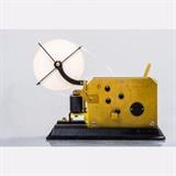 LOT 95 - A Telegraph Pen Register with Tape Roll
Dimensions: H: 9 W: 12 D: 5 in.
Est: $400-600

Description A Telegraph Pen Register with Tape Roll by J.H. Bunnell & Co., Brooklyn NY, Late 19th/Early 20th Century. 'New' old stock.
