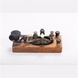 LOT 97 - A Telegraph Key for Radio Transmitter
Dimensions: H: 2 W: 6 1/2 D: 2 3/4 in.
Est: $10-20

Description A Telegraph Key for a Radio Transmitter, 20th Century.