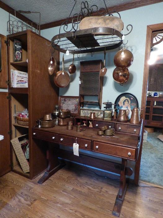 Pine trestle desk, cast iron pot hanger, misc. copper cookware, mixing bowls, antique washboard made into wall cabinet