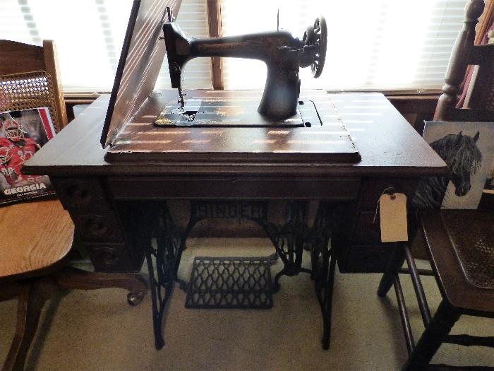 Antique treadle Singer sewing machine in cabinet
