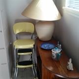 Kitchen stool; table lamp; shelf (all wood); knick knacks.