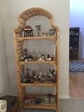 Rattan shelf, displaying numerous knick knacks.