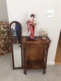 small table; mirror; doll; ginger jar