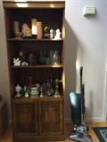 shelf in the entry way, displaying miscellaneous knick knacks.  Royal upright vacuum.
