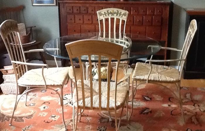 glass table with iron legs and 4 iron/rattan chairs