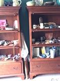 Matching oak bookcases filled with pottery