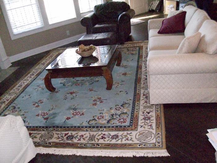 Blue Chinese pattern wool rug. 8' 3" x 12'. Machine made in Belgium $250.00.  Oriental design coffee table w/glass. Leather chair and ottoman.