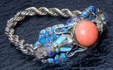 Chinese silver and enamel dragon bracelet with a huge round cabochon of coral in its center