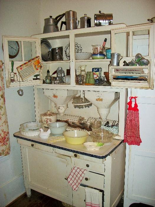 Some awesome antique and vintage kitchen items in an amazing hoosier cabinet.