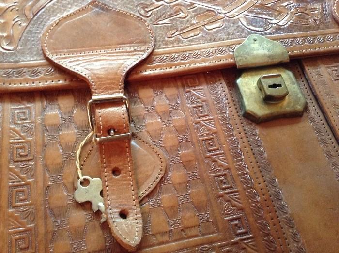 Intricate leather briefcase with key