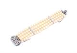 Lot 88: A FOUR-STRAND PEARL BRACELET WITH DIAMOND CLASP