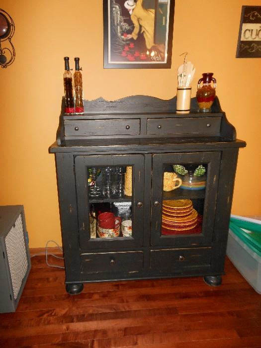 black cabinet and dishes