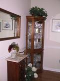 Lots of waterford displayed in curio. Marble top piece is out of Biltmore Estate, with certificate.