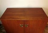 Mid Century Modern, solid wood stereo cabinet (no stereo).  Lift top, double piano hinged doors.  Would make a great home bar.
