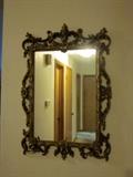 Vintage ornate wall mirror, carved wood frame, painted gold.