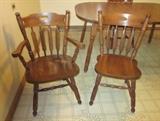 Solid wood kitchen table (laminate top) with one leaf and five solid wood chairs (1 arm chair and 4 side chairs).