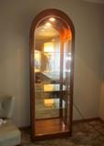 Dome top curio cabinet by Philip Reinisch.  Oak with mirrored back, glass shelves, lighted, side access.
