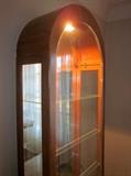 Dome top curio cabinet by Philip Reinisch.  Oak with mirrored back, glass shelves, lighted, side access.
