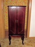 Dark cherry jewelry armoire, 6 drawers, side necklace racks and storage area under top.