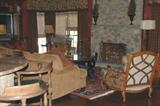 Large French Provincial cherry and upholstered chair, black painted glass top stretcher base octagonal coffee table.