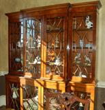 Magnificent breakfront with glass shelves and lighting.