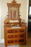 Antique Eastlake Victorian dresser with candle step ups and marble top.