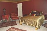 Morrocan style bedroom set--queen bed with bedding, chair and ottoman, table with table skirts, side table, rugs, accessories