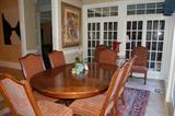 Oval cherry dining table with 8 French stretcher base chairs, cherry spice cabinet with labelled drawers, black tole plant stand