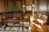Lyre pedestal leather top Duncan Phyfe desk, Alligator design rolling arm/desk chair, decorator console table with carved lion's heads, armless French upholstered chair, geometric pattern hand knot rug.