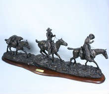 Large Charles M. Russell "Changing Outfits" solid bronze sculpture on a wooden base, from Chesapeake Reproductions. Excellent condition! 34 1/2" long x 12 1/2" high. Item cannot be shipped: winning bidder must pick up this item in person at our San Antonio, Texas gallery.