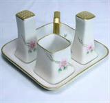 Lot of 4 pieces of vintage Limoges French hand-painted porcelain: salt, pepper & condiment set on a tray with pink floral design, signed “Caroline”. 5” wide tray. No apparent damage.