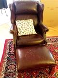 A leather wingback and ottoman