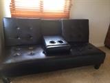 SOLD. Leather sleeper sofa w/ full size futon and middle cup holder arm rest.