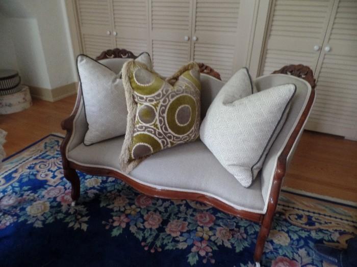 Lovely antique settee upholstered in linen.    Please note: not all decorative pillows are included in sale
